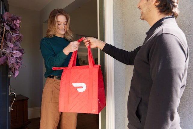 Hans Air Express courier agent completing doorstep parcel handover to customer